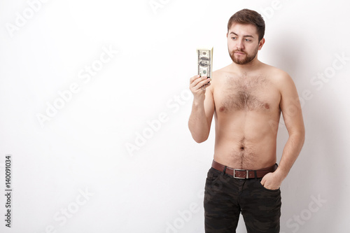 young handsome man with beard holding a lot of hundred-dollar bills. money. 