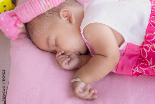 Fotografi portrait of baby sleep and sucking finger.
