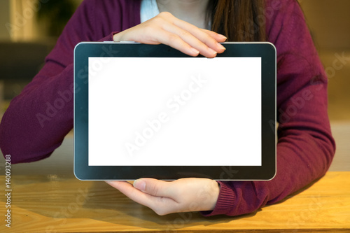 Woman using tablet in coffee shop