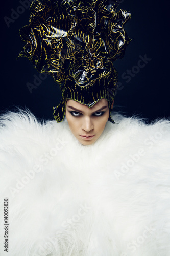 Woman in headwear and fur coat 