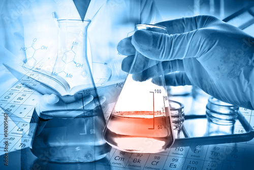 Flask in scientist hand with laboratory background 