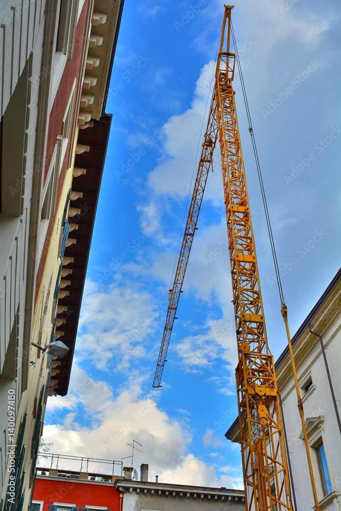 The yellow crane in the blue sky.