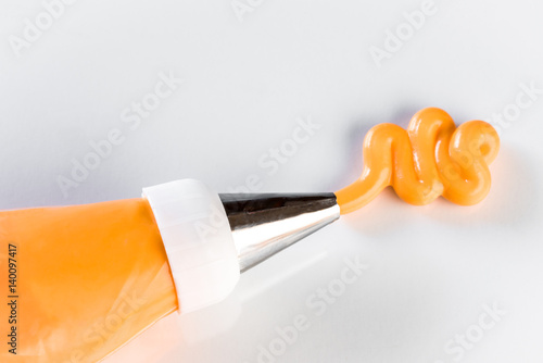 Принти на полотні Orange Icing on White Background