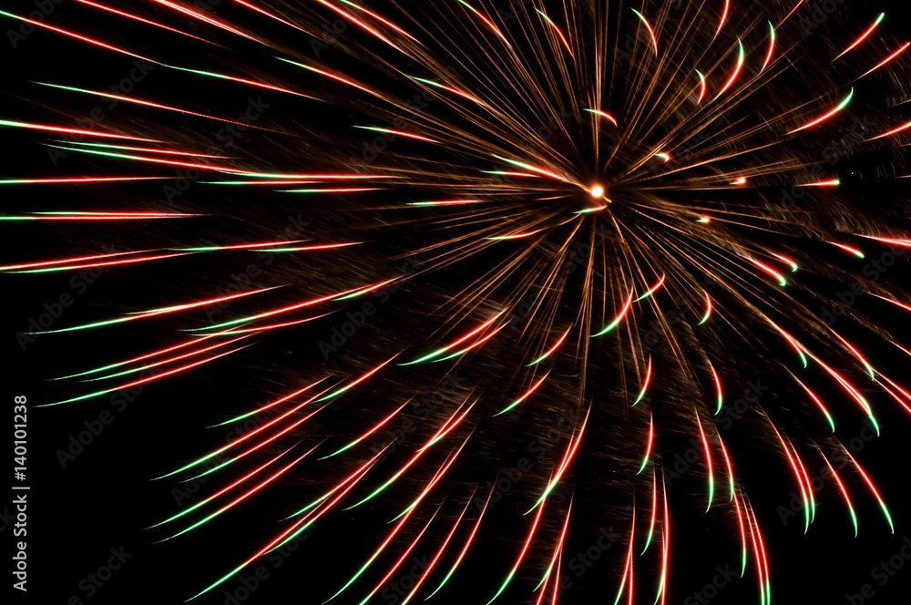 big red and green firework on black background big red and green firework on black background