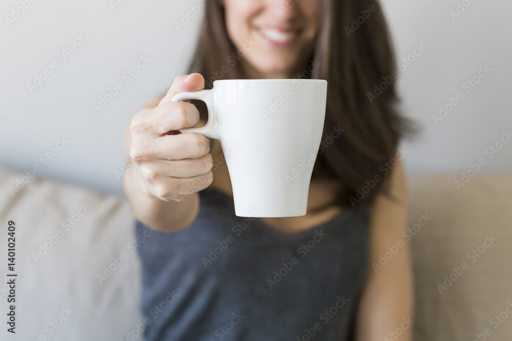 close up of woman hands holding a cup of coffee in her bedroom close up of woman hands holding a cup of coffee in her bedroom