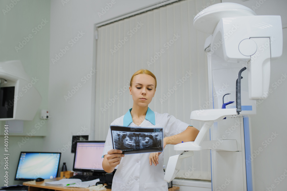 dentist analyzes a dental panoramic x-ray film