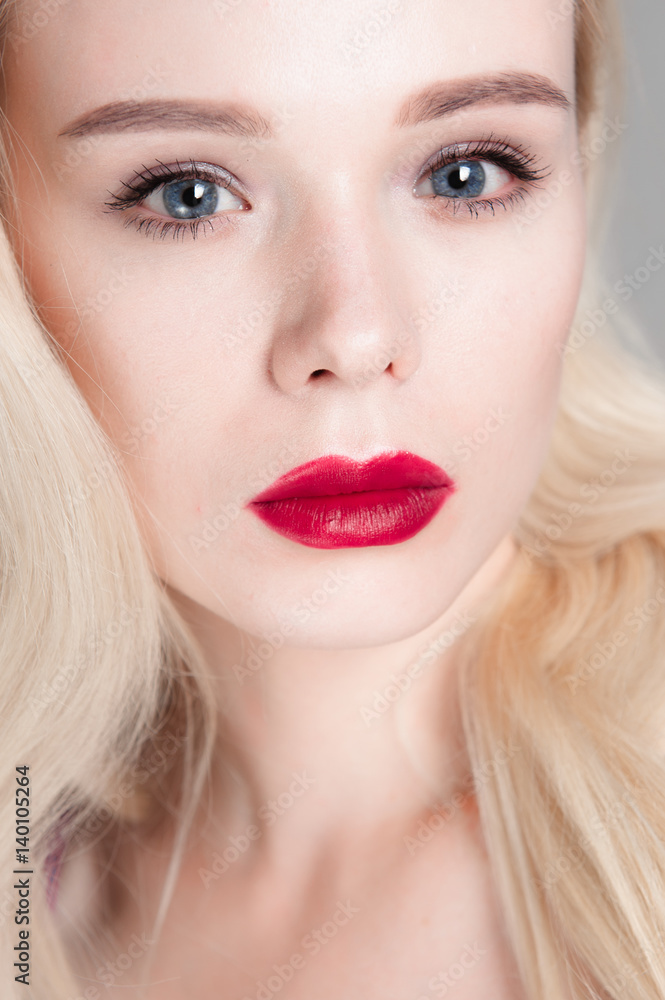 Beauty model girl with perfect make-up red lips and blue eyes looking at camera, wearing magenta bra. Portrait of attractive sexy young woman with blond hair. Beauty model girl with perfect make-up red lips and blue eyes looking at camera, wearing magenta bra. Portrait of attractive sexy young woman with blond hair.