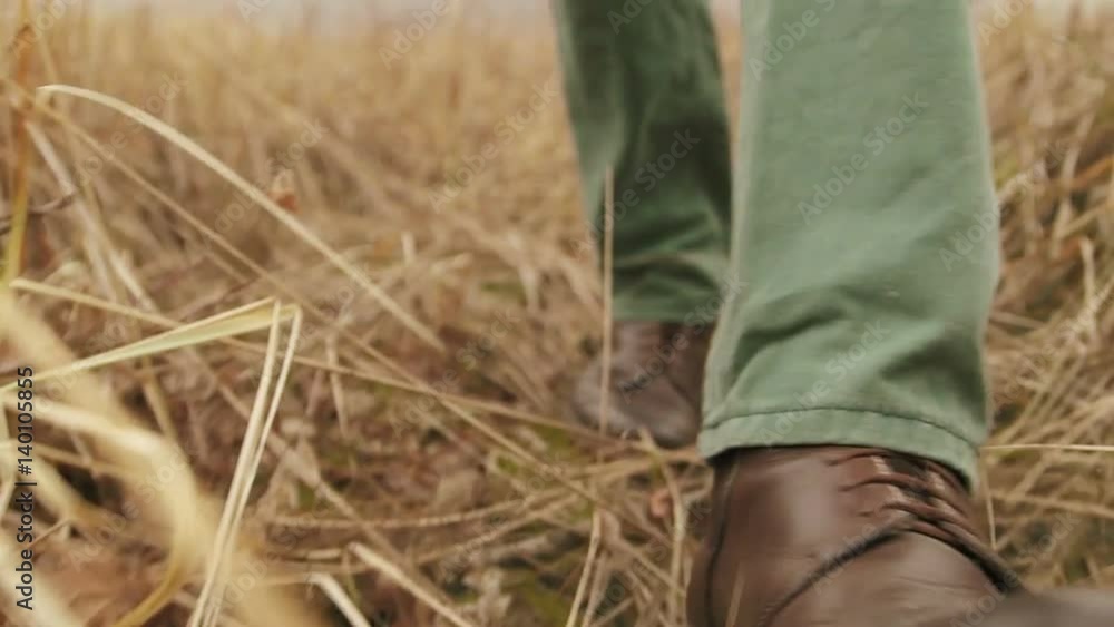 Hiker in close-up slow motion leg shot walks uphill in the forest Hiker in close-up slow motion leg shot walks uphill in the forest