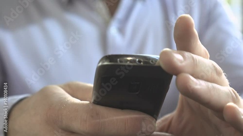 Close up on businessman hands sms typing, using smartphone app, steadicam shot