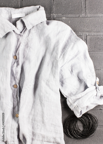 Women's linen shirt on a black background, soft focus, vertical
