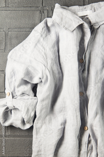 Women's linen shirt on a black background, soft focus, vertical
