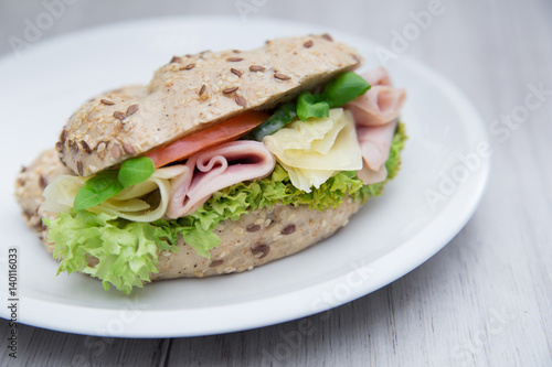 Baguette sandwich with ham, cheese, tomatoes and lettuce