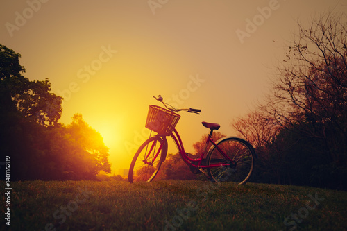 Landscape image of vintage bicycle on beautiful sunset © Mymemo