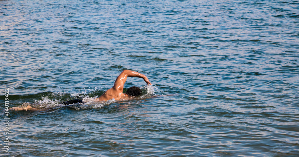 man swimming in lake ontario