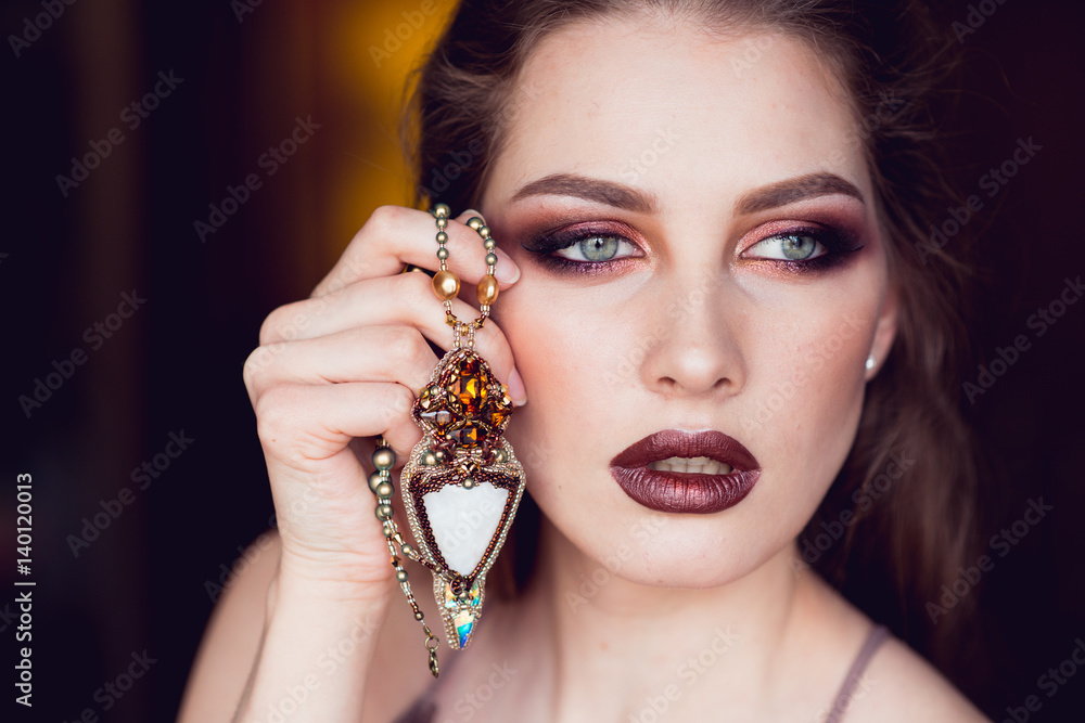 Portrait of beautiful girl with jewellery on the neck