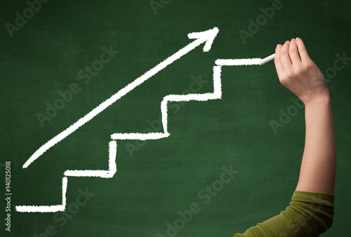 Hand drawing steps on blackboard