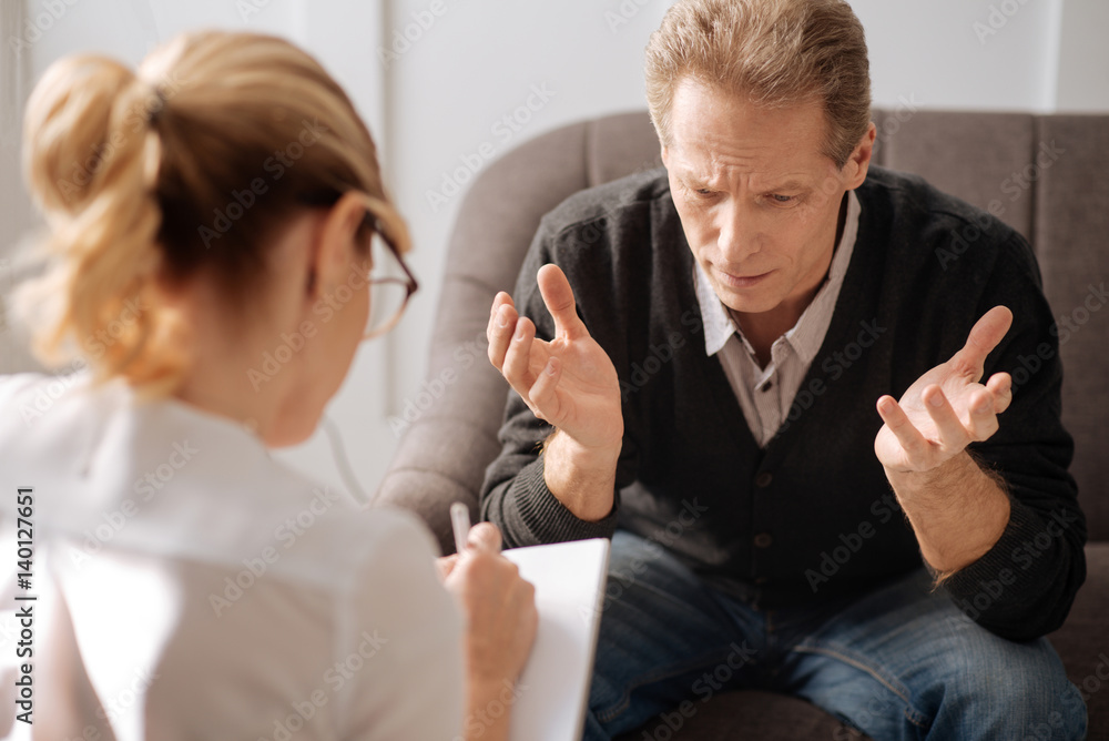 Unhappy depressed man speaking about his problems Unhappy depressed man speaking about his problems