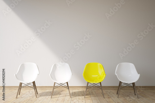 Three white chairs and a yellow one photo