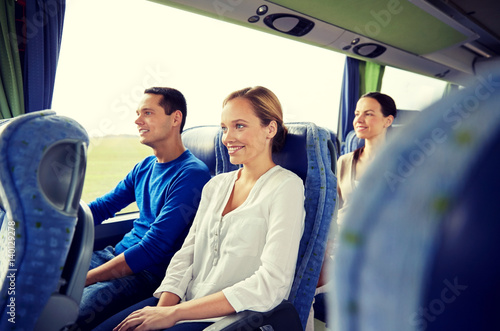 group of happy passengers in travel bus