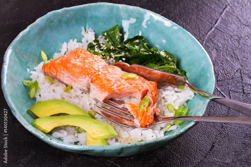 Salmon with spinach and avocado. Fish with rice and sesame seeds Salmon with spinach and avocado. Fish with rice and sesame seeds