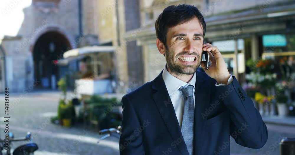 A businessman after a working visit to exult phone to have received a promotion or winning a bet. Concept: finance, business, exultation, victory, bet, working career. A businessman after a working visit to exult phone to have received a promotion or winning a bet. Concept: finance, business, exultation, victory, bet, working career.