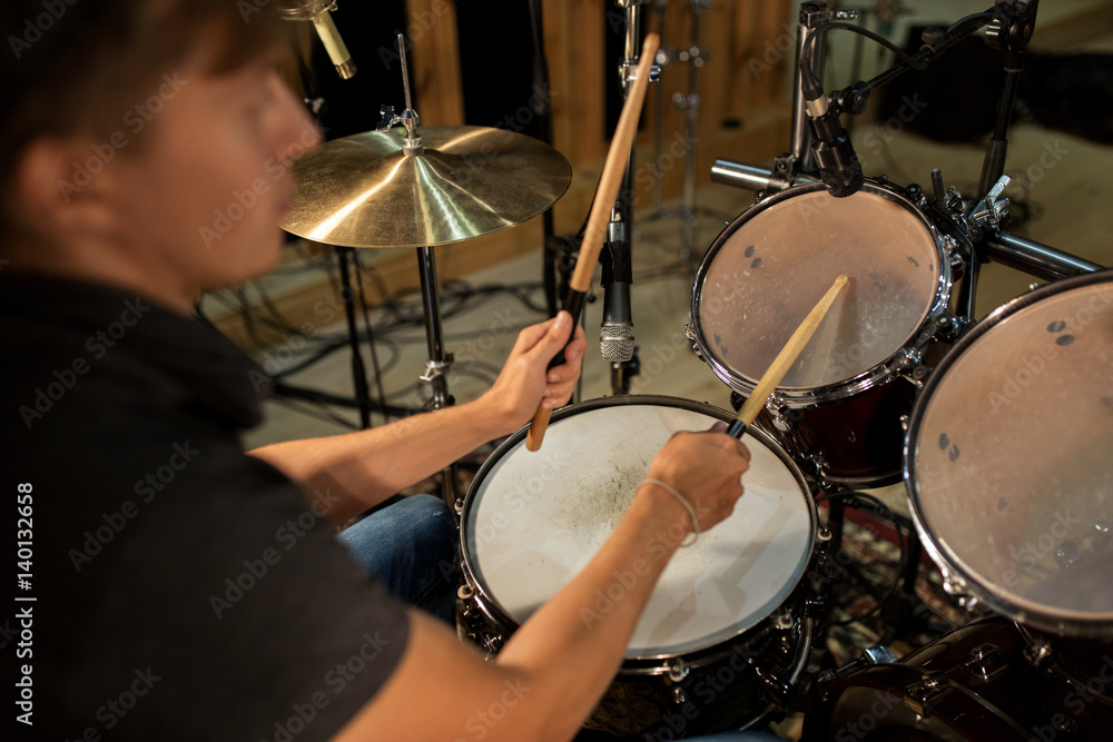 male musician playing drums and cymbals at concert male musician playing drums and cymbals at concert