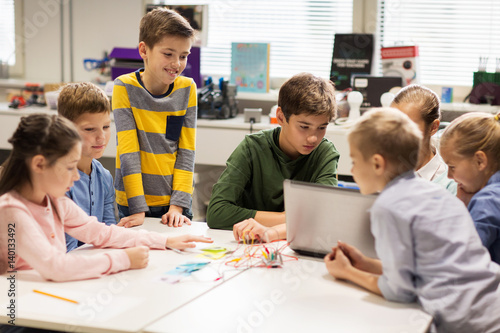 happy children with laptop at robotics school