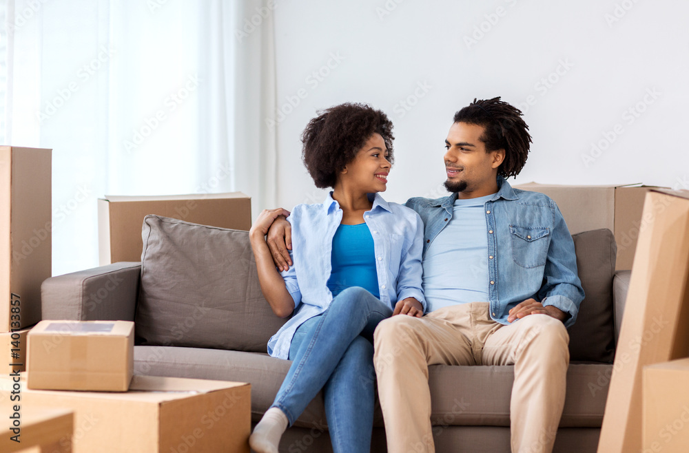 happy couple with boxes moving to new home