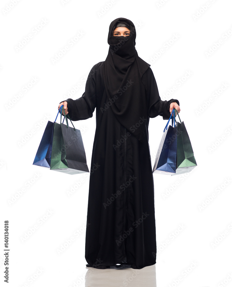 muslim woman in hijab with shopping bags muslim woman in hijab with shopping bags