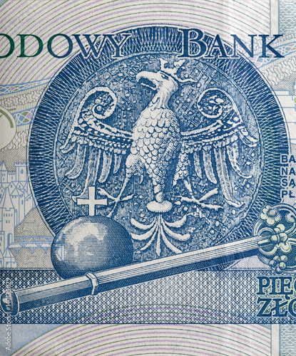 Eagle, the emblem of Poland depicted on zloty banknote macro photo