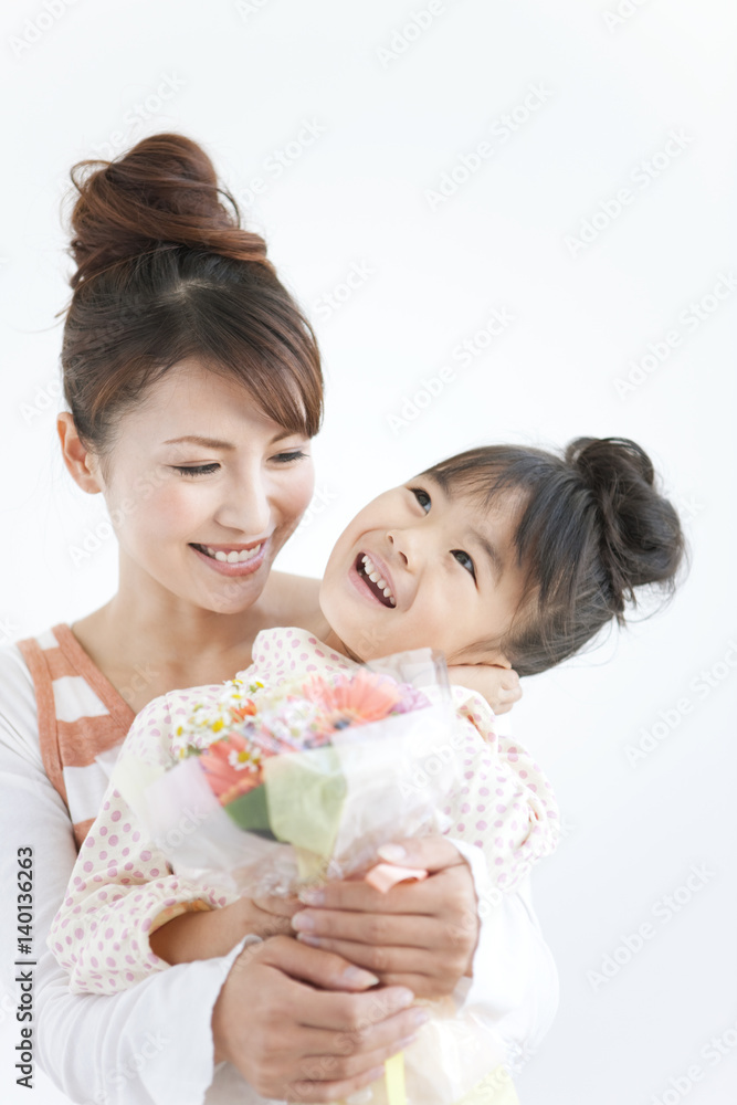 Girl with mother holding flower bouquet, white background Girl with mother holding flower bouquet, white background
