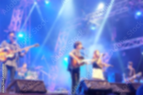 Blurred background : Bokeh lighting in outdoor concert with musicians on the stage