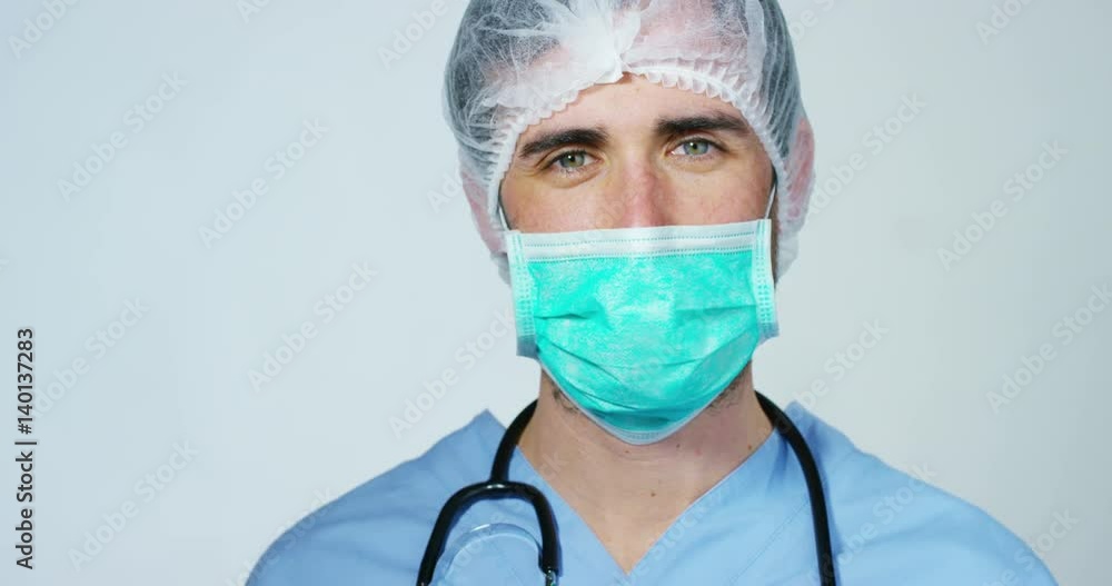 close up portrait of a surgeon or doctor with mask and headset ready for operation in hospital or clinic. The surgeon smiles safe and proud of himself. Concept of medicine, hospitals and doctors, care close up portrait of a surgeon or doctor with mask and headset ready for operation in hospital or clinic. The surgeon smiles safe and proud of himself. Concept of medicine, hospitals and doctors, care