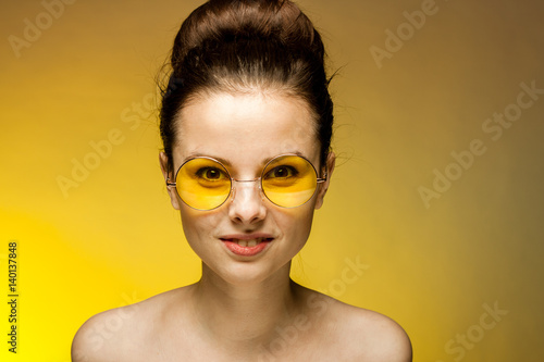 brunette woman in yellow glasess