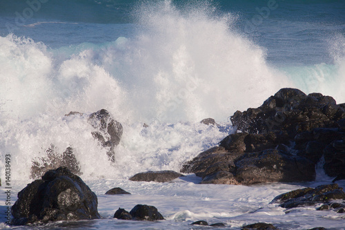 Large waves from winter swells breaking on the rocks in Maui, Hawaii