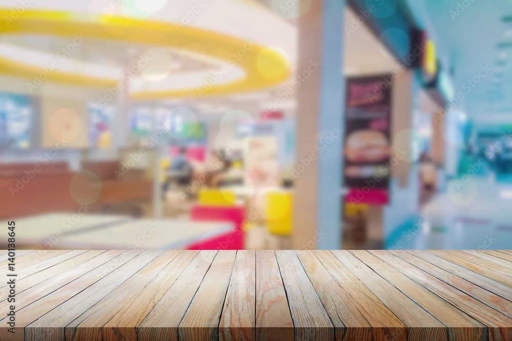 Perspective wood over blurred restaurant with bokeh background, foods and drinks, product display montage Perspective wood over blurred restaurant with bokeh background, foods and drinks, product display montage