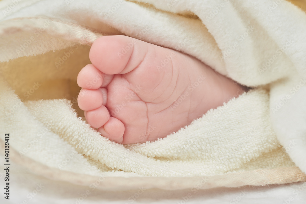 Newborn baby feet on a white towel Newborn baby feet on a white towel