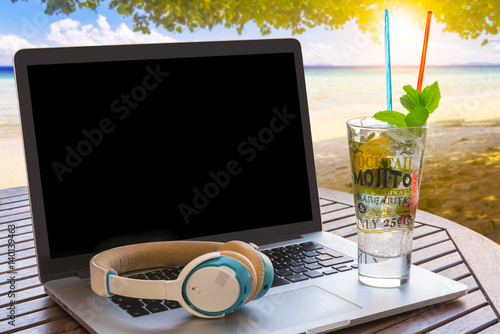 Modern laptop on the beach photo