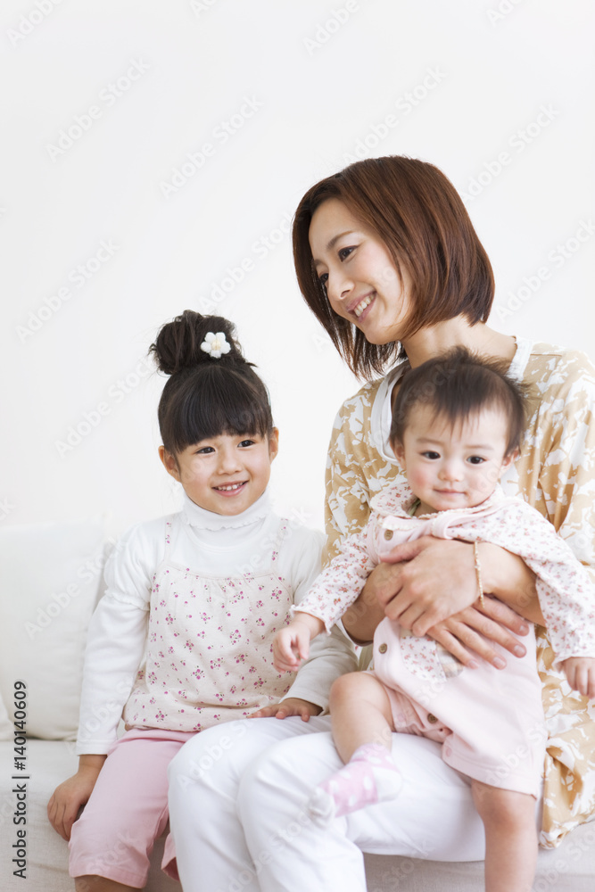 Mother with kids sitting on sofa Mother with kids sitting on sofa