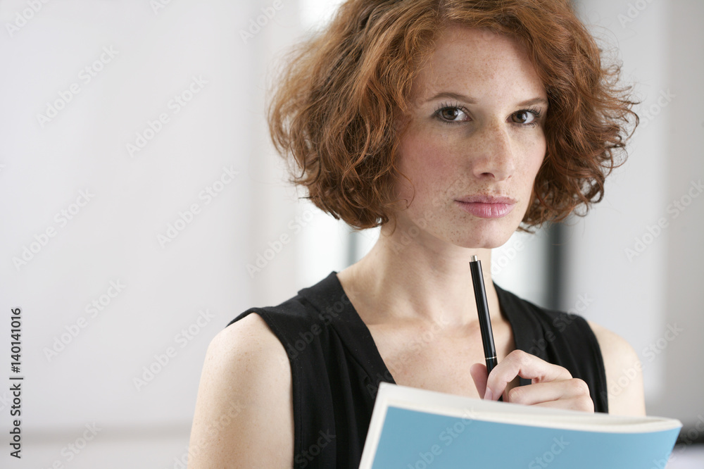 Reflective young woman looking at camera