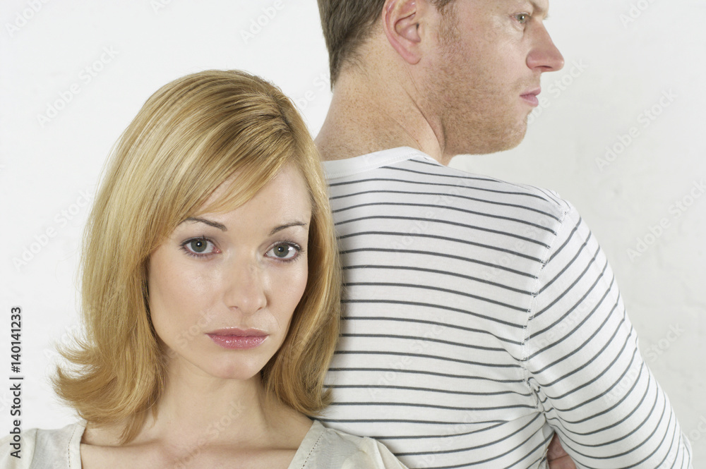 Frustrated couple standing back to back Frustrated couple standing back to back