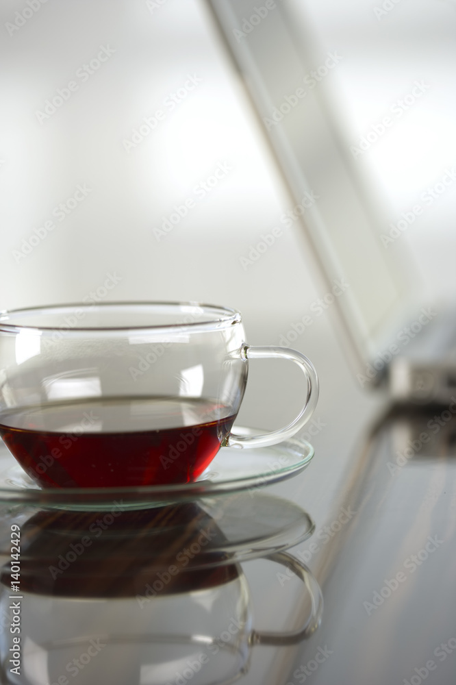 A cup of tea next to a laptop A cup of tea next to a laptop