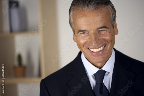 Senior businessman smiling
