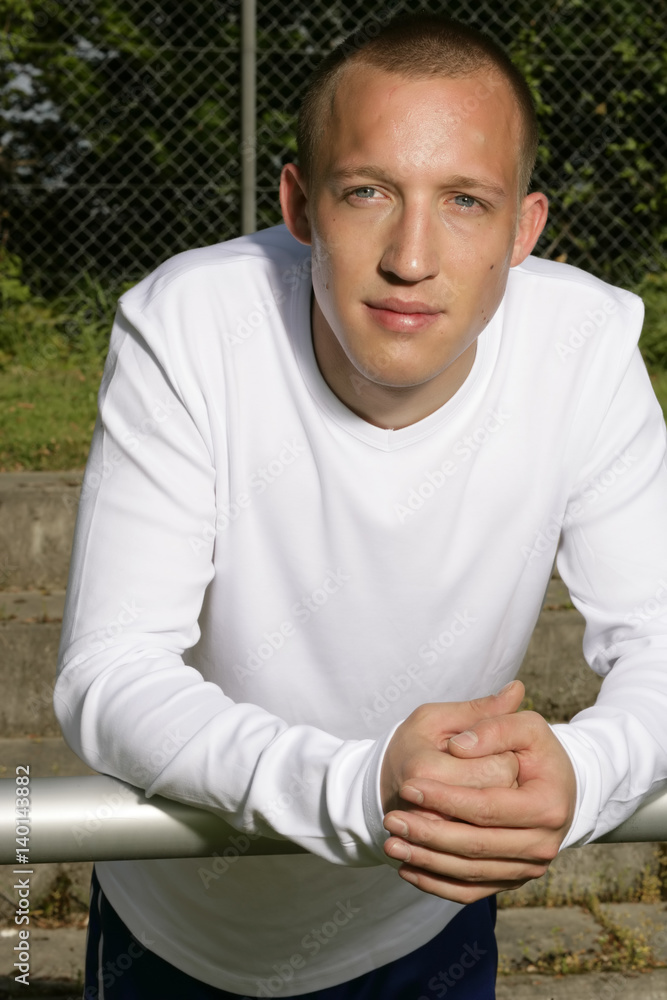 Young man with a sweaty face leaning on a balustrade, close-up Young man with a sweaty face leaning on a balustrade, close-up