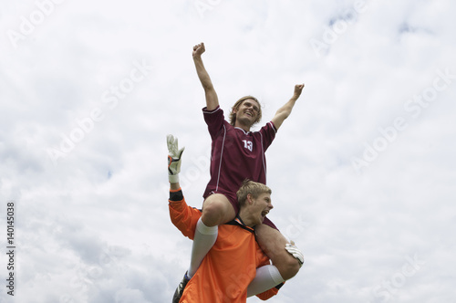 Kicker sitting on cheering goalkeeper's shoulders © Gudrun