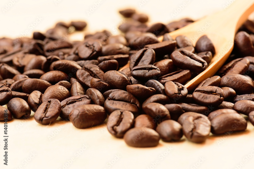 Coffee beans and wooden scoop on wooden background. Coffee beans and wooden scoop on wooden background.