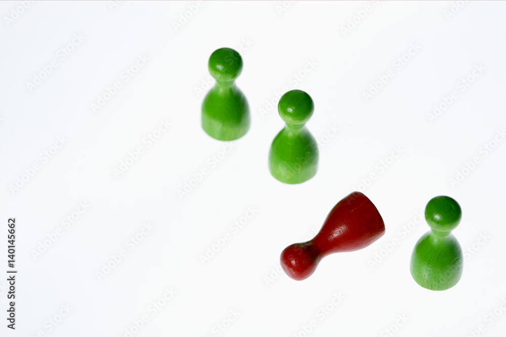 Lying red game piece between green ones