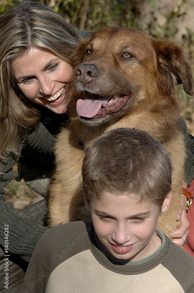 Group of  a laughing woman, a boy and a brown dog