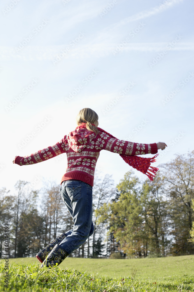 Young woman running happily over a meadow Young woman running happily over a meadow