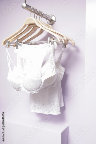 White lacy underwear hanging on coat-hangers